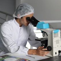 a man looking through a microscope