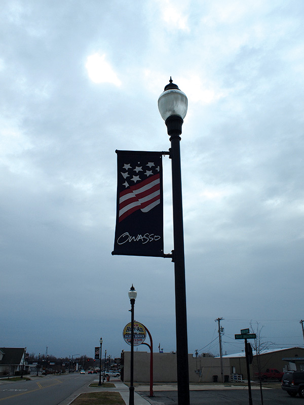 a lamp post with a flag on it