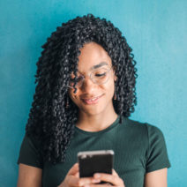 a woman using a smartphone to send a text